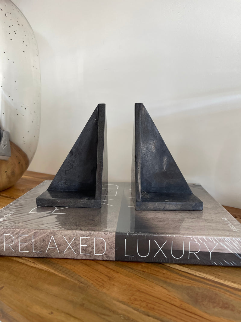 Decorative shelf with 'Relaxed Luxury' text on a wooden surface.