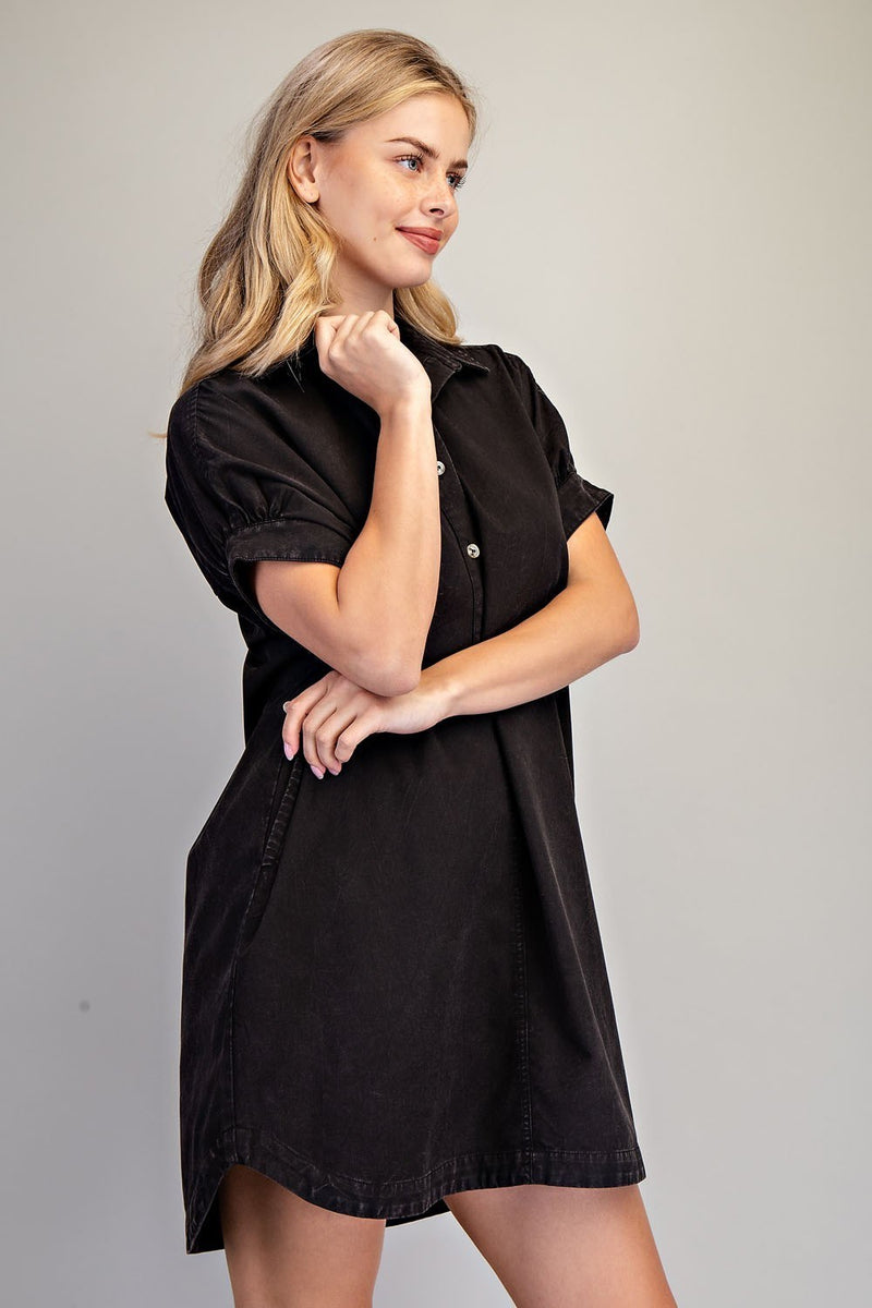 Woman wearing a black dress against a gray background